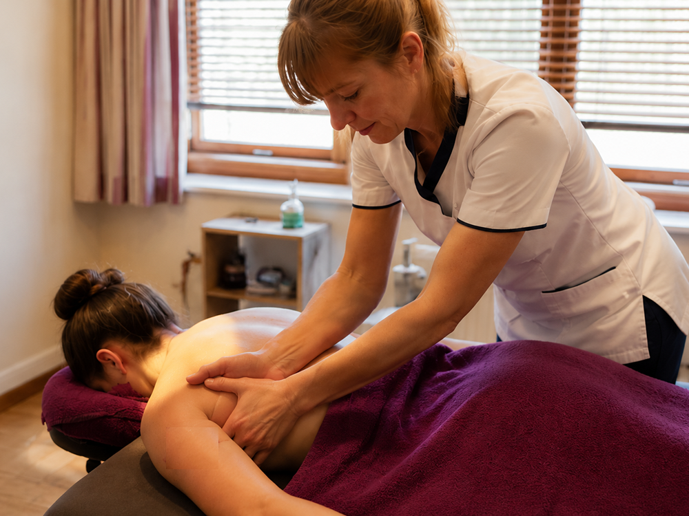Client shoulder being massaged